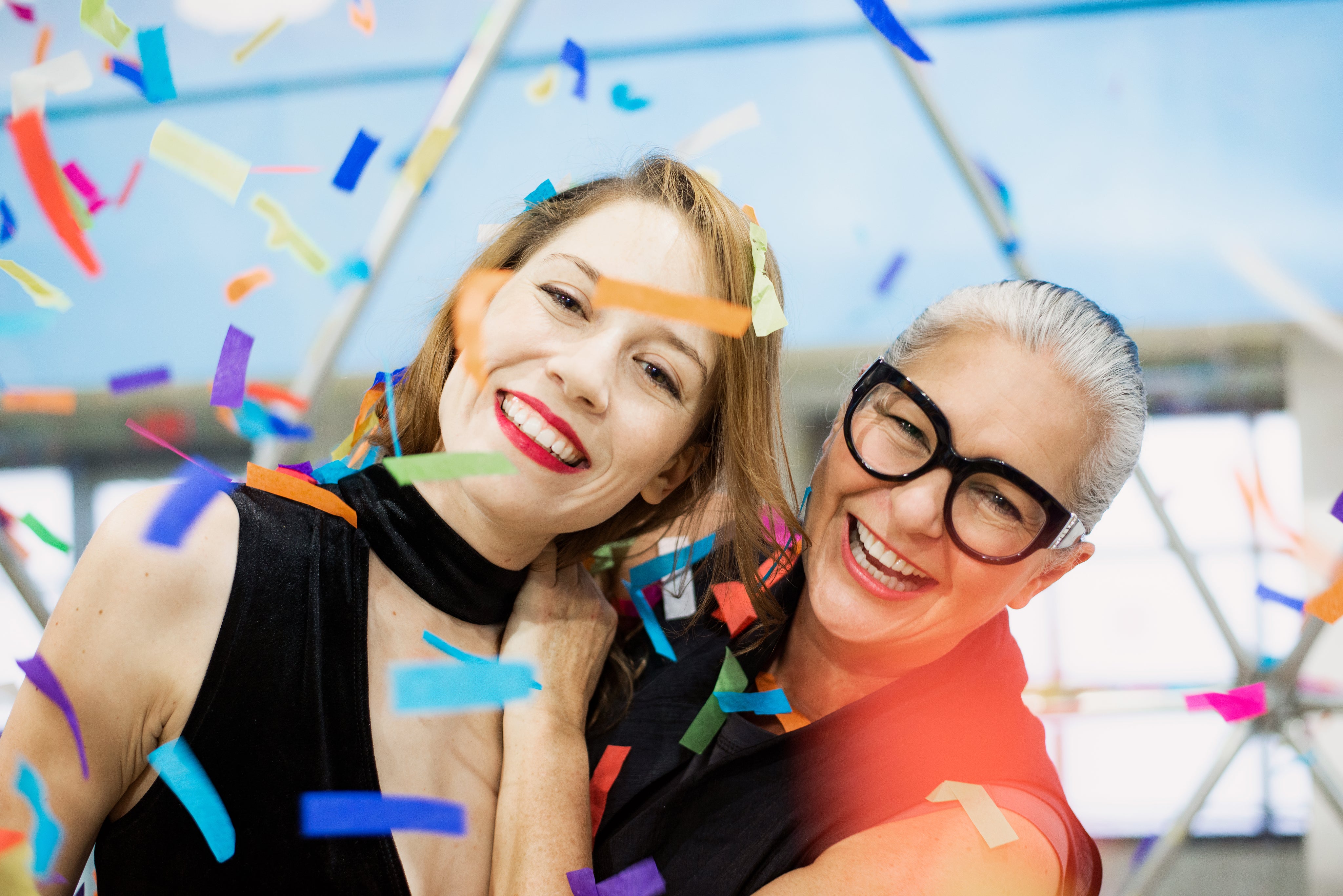 files/two-women-smiling-in-a-blizzard-of-rainbow-paper-confetti.jpg